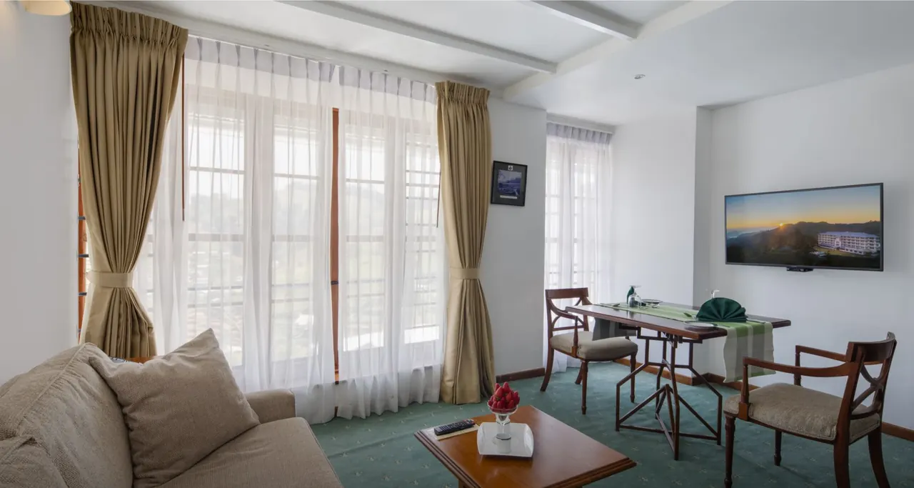 Junior Suite sofa and dining area — Heritance Tea Factory